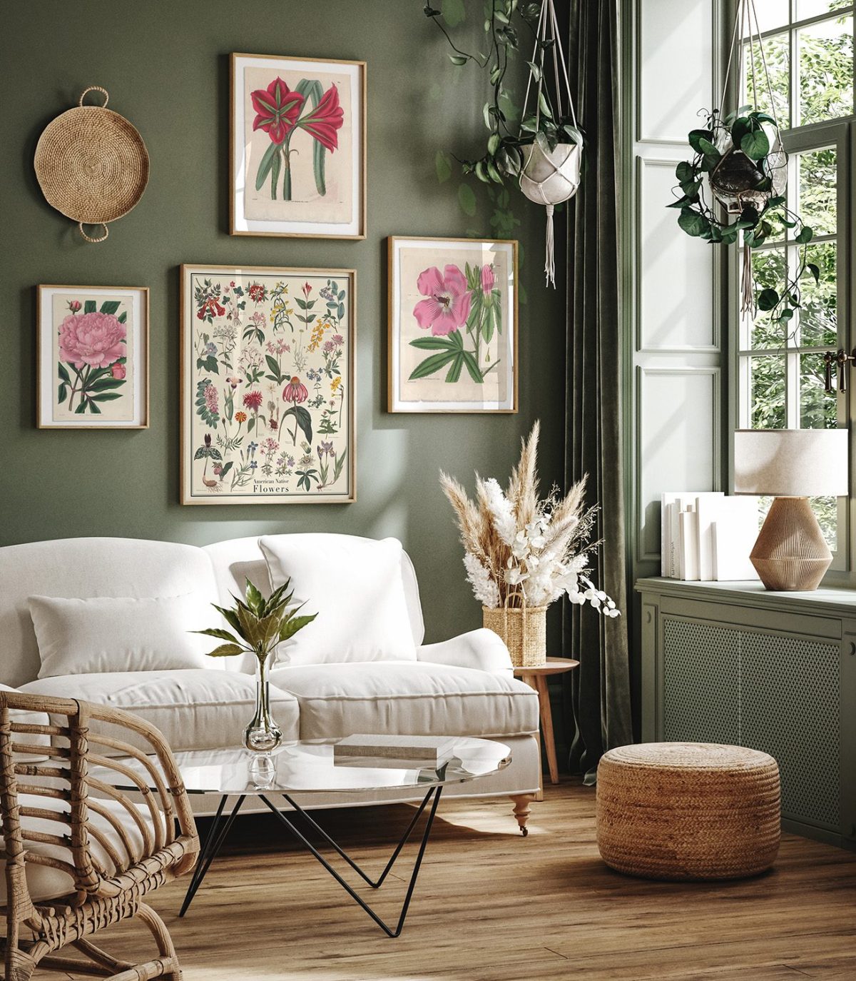 Living room with green walls and pink and red framed botanical prints.